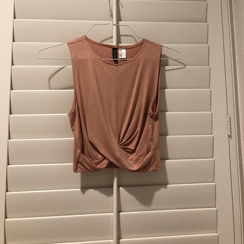 Tank top with twist detailing in the front.